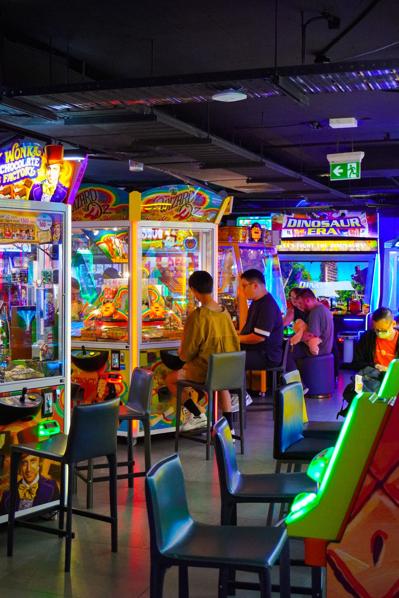 People playing in a colourful arcade