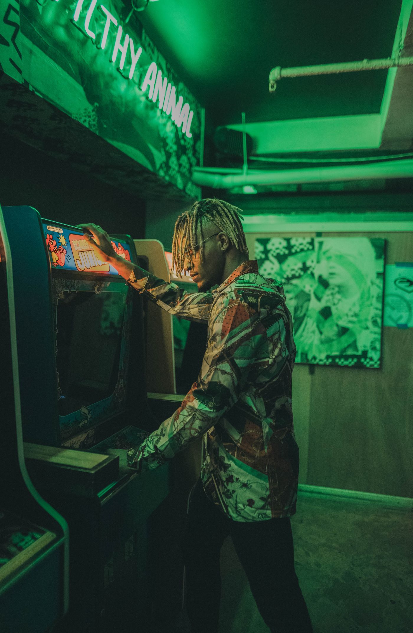 Player leaning on a neon arcade machine